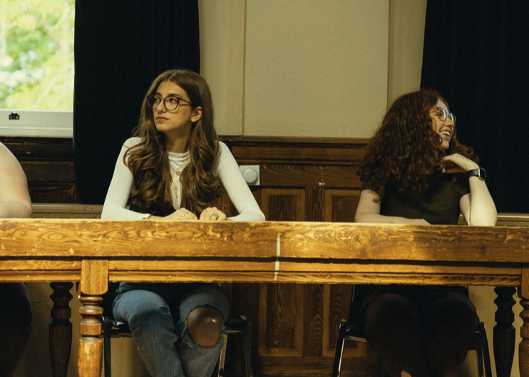 Students sitting and listening at a table