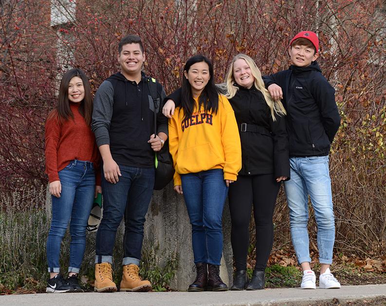 Five English Language Communication & Culture students smiling for the camera.