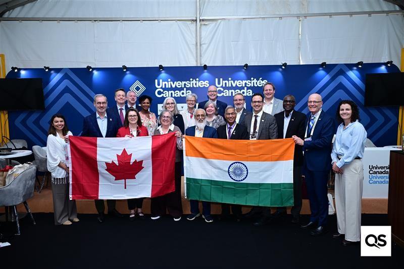 University leaders stand in front of Canadian and Indian flags