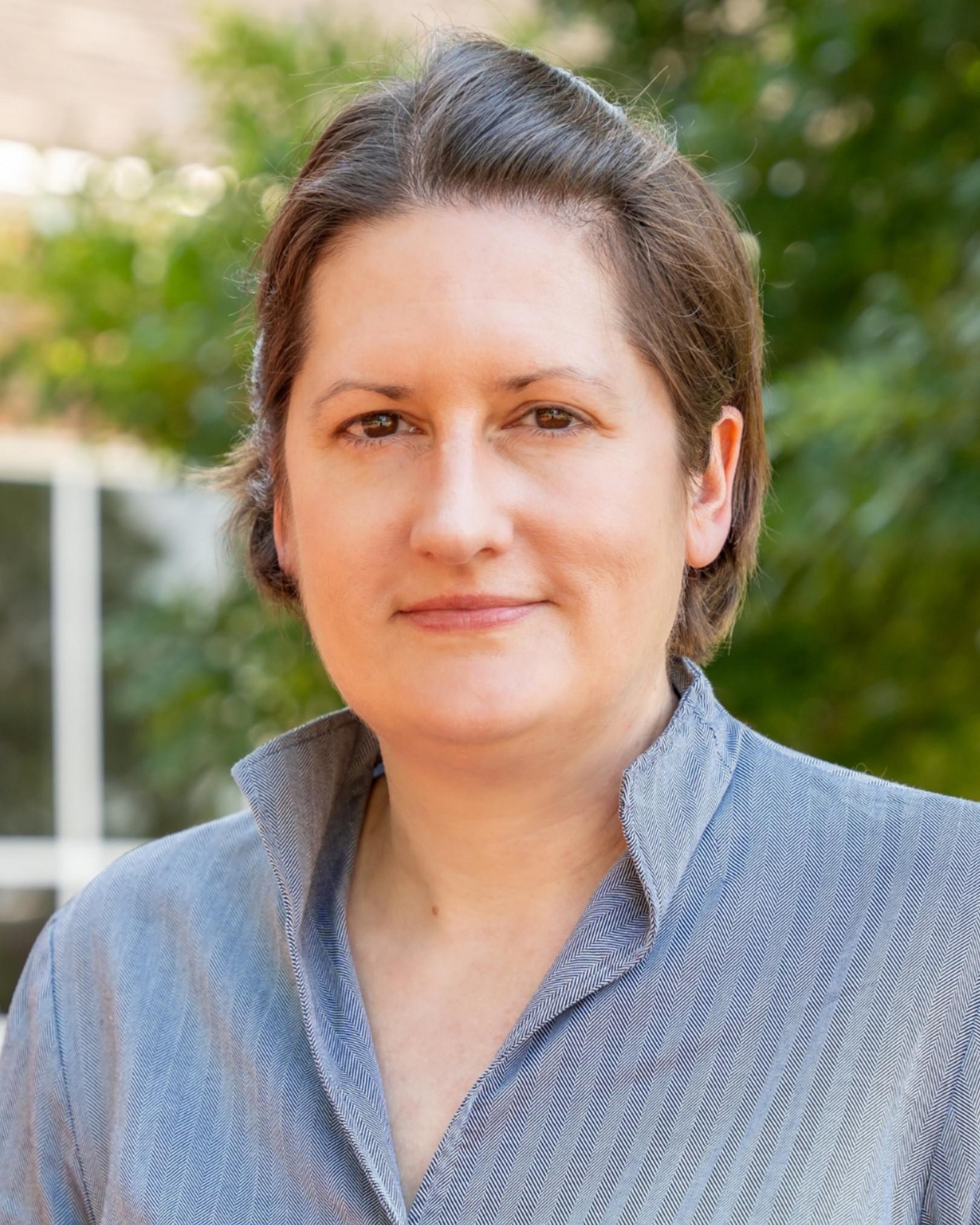 caucasian woman with short brown hair and brown eyes
