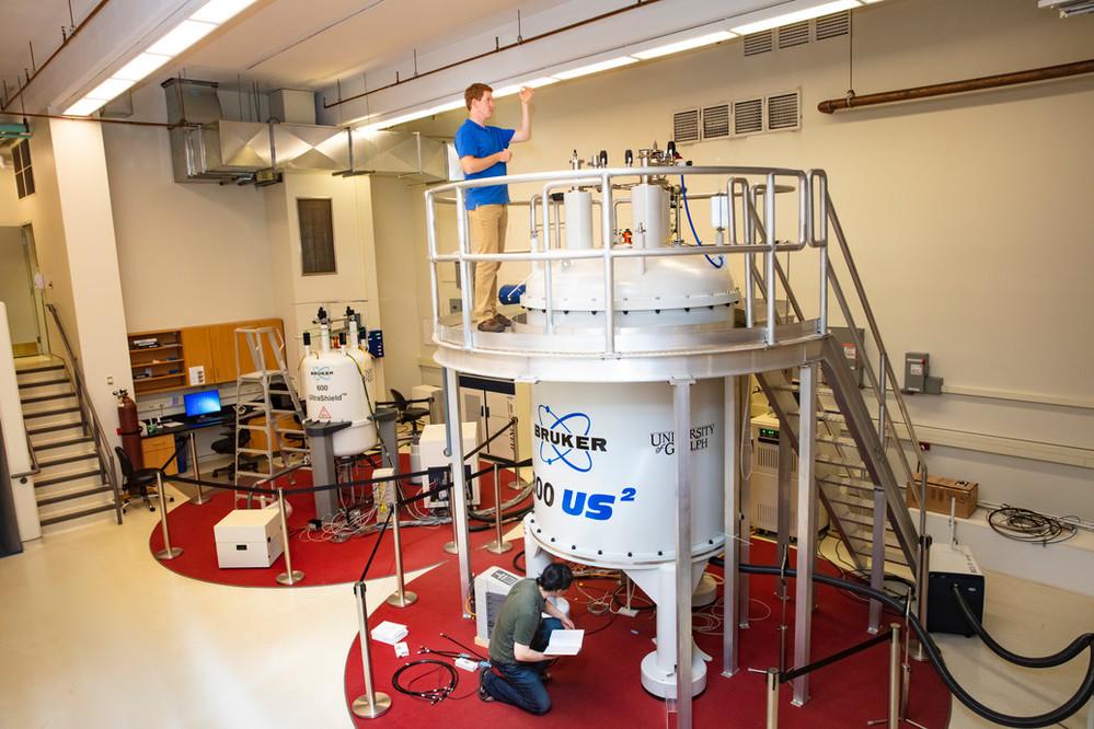 Two graduate students are working in U of G's NMR Centre