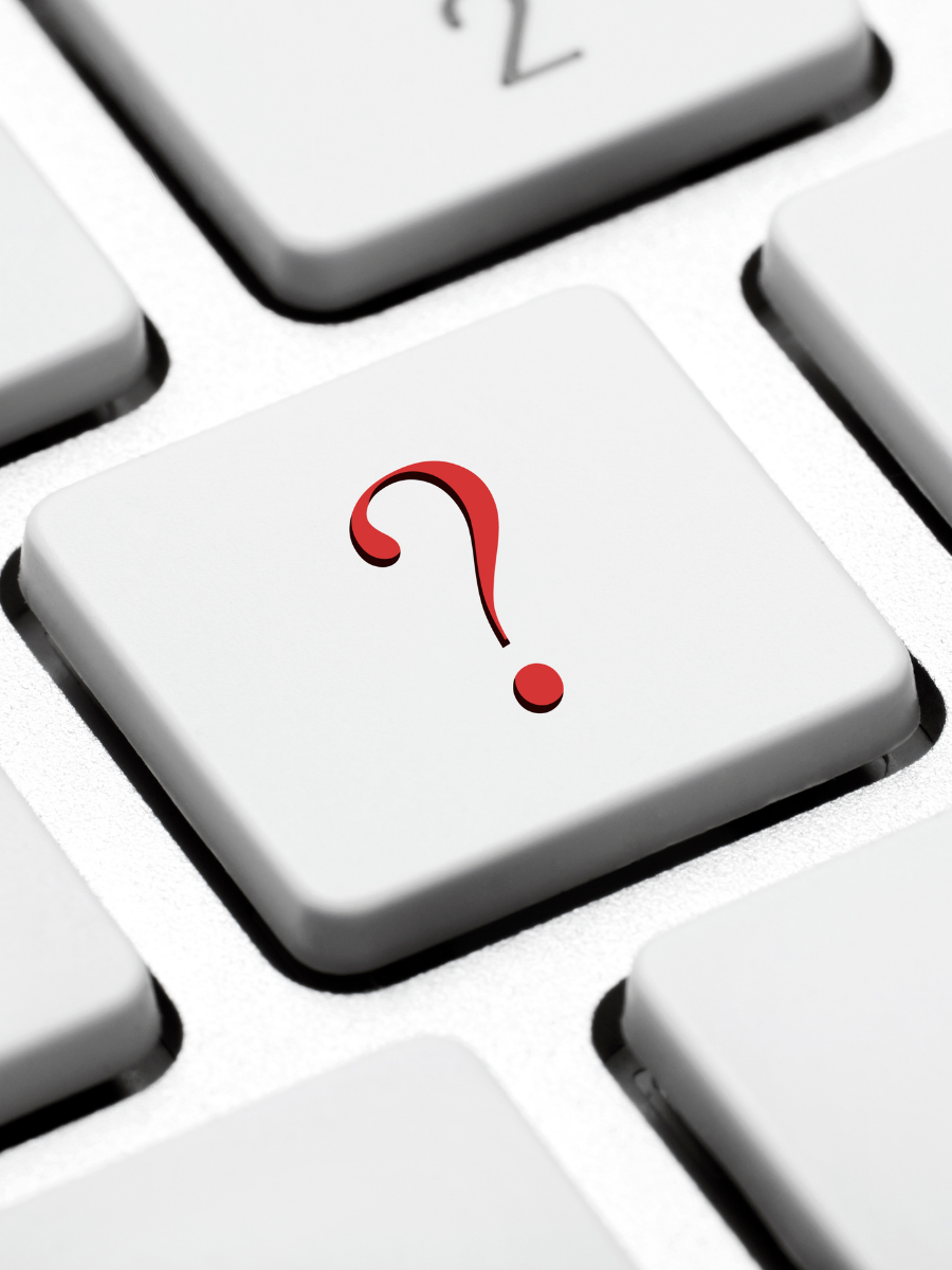 Part of a computer keyboard with a question mark on one of the keys