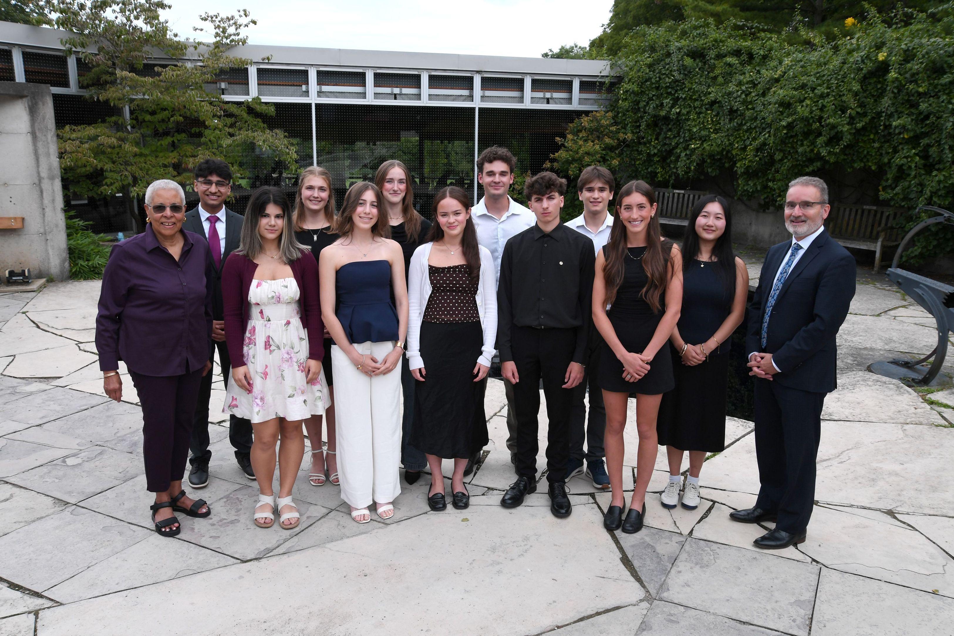 2026 Scholars posing for a group photo outside with the President and Chancellor 