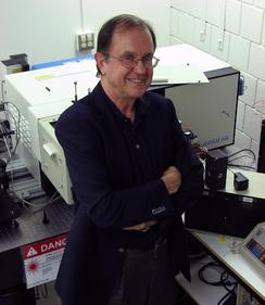 Dr. Peter Tremaine standing with his arms crossed and smiling at the camera.