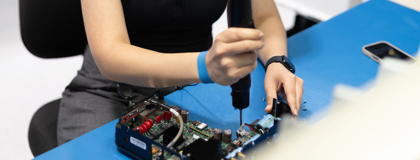A student works on an electronics board
