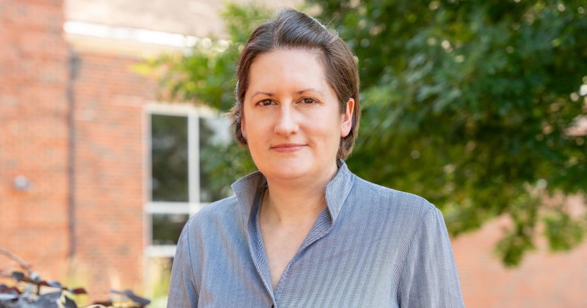 ovc dean standing in front of a building with a smile on her face
