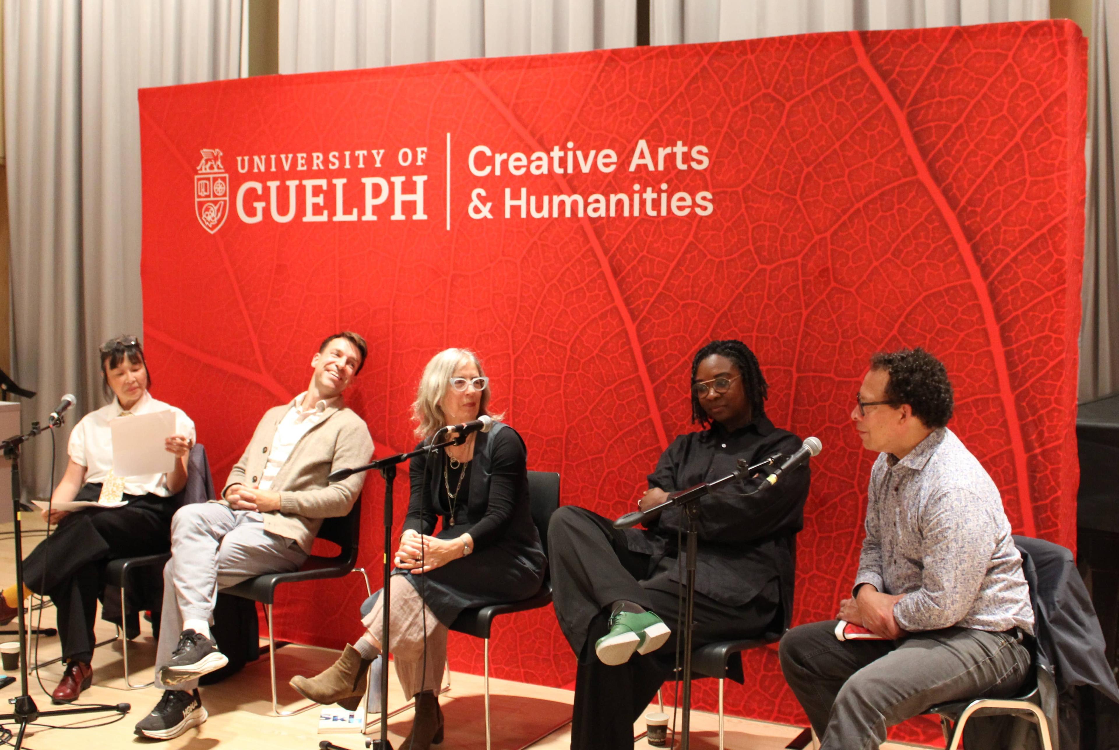 Acclaimed authors and Creative Writing faculty members Carrianne Leung, Blain Watters, Catherine Bush, Canisia Lubrin and Lawrence Hill in conversation at the Gryphons Read 2026 Creative Writing event in the auditorium in the Arts Research Centre at the University of Guelph. In the background is a banner featuring a logo which includes the University of Guelph emblem, text reading "University of Guelph" and text reading "Creative Arts and Humanities."