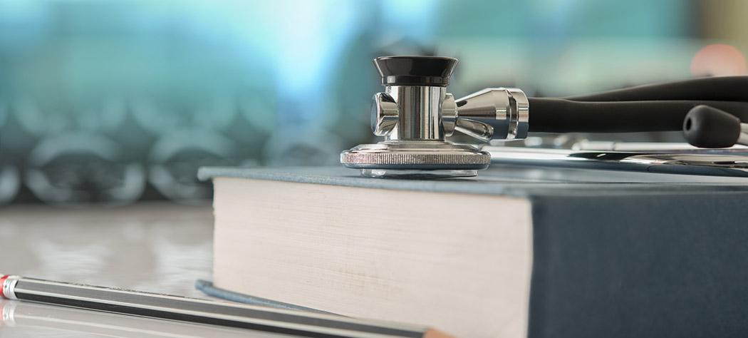Stethoscope sitting on a book (iStock-986464180)