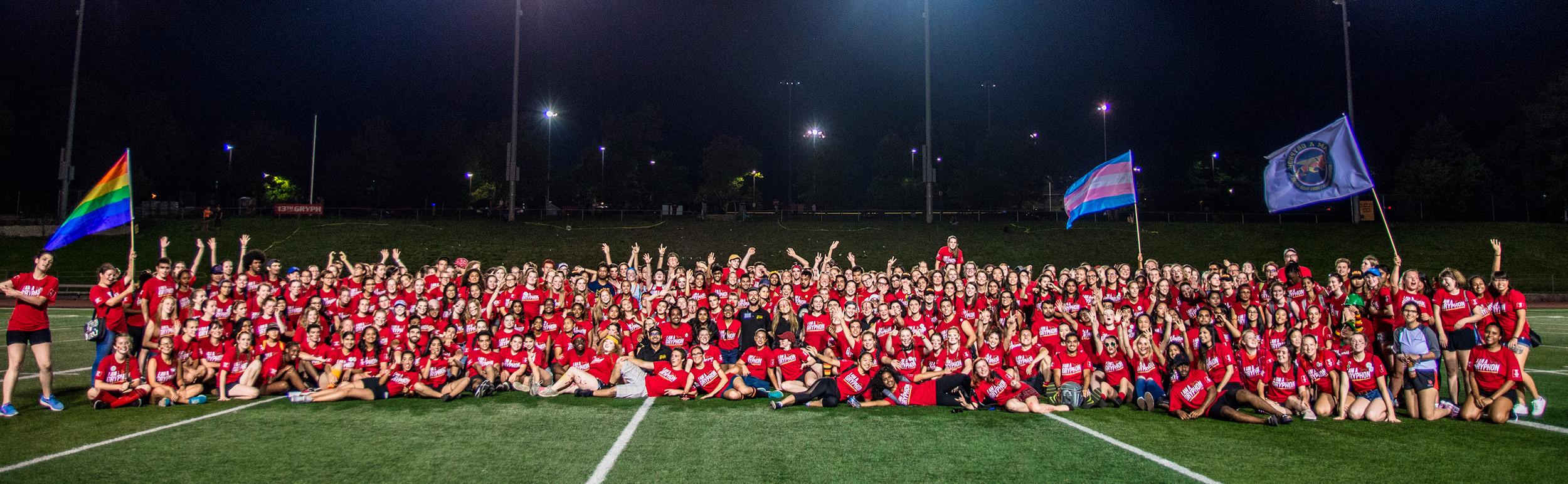 Orientation Volunteers (OVs) in a group on the football field after Pep Rally