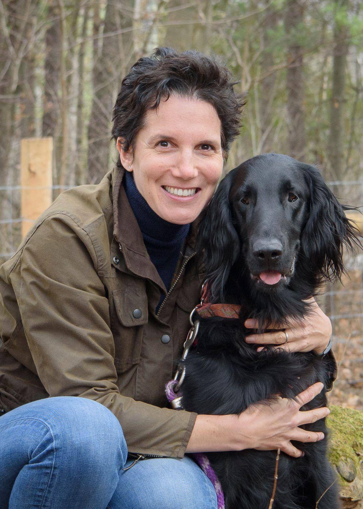 Alice Defarges head and torso shot, with her holding her dog Stan