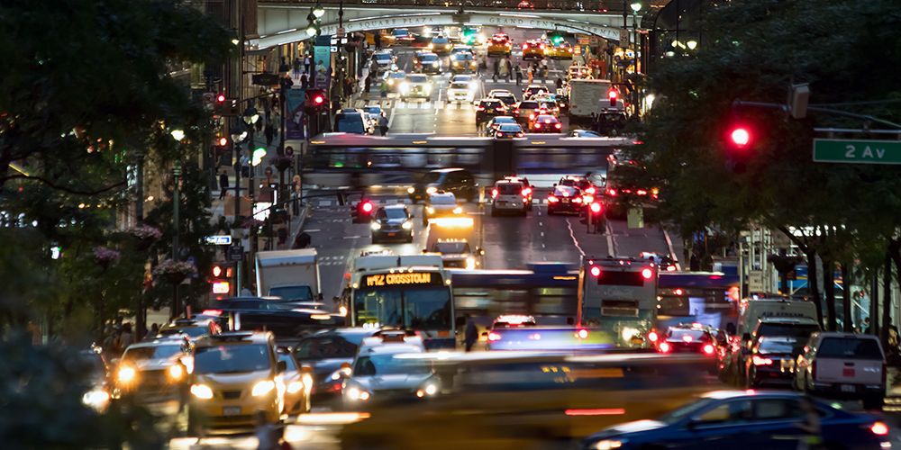 A busy street in New York City bustles with traffic
