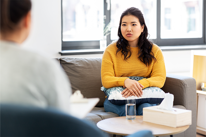 A young woman talks to a therapist