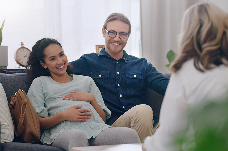 a pregnant couple talks to a therapist
