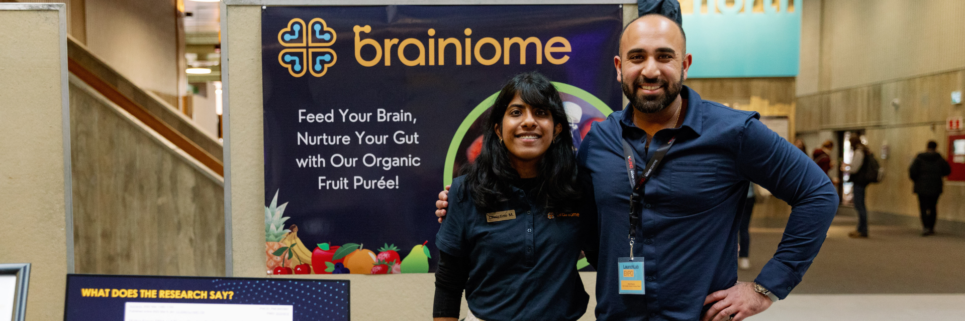 2 people standing in front of a poster board