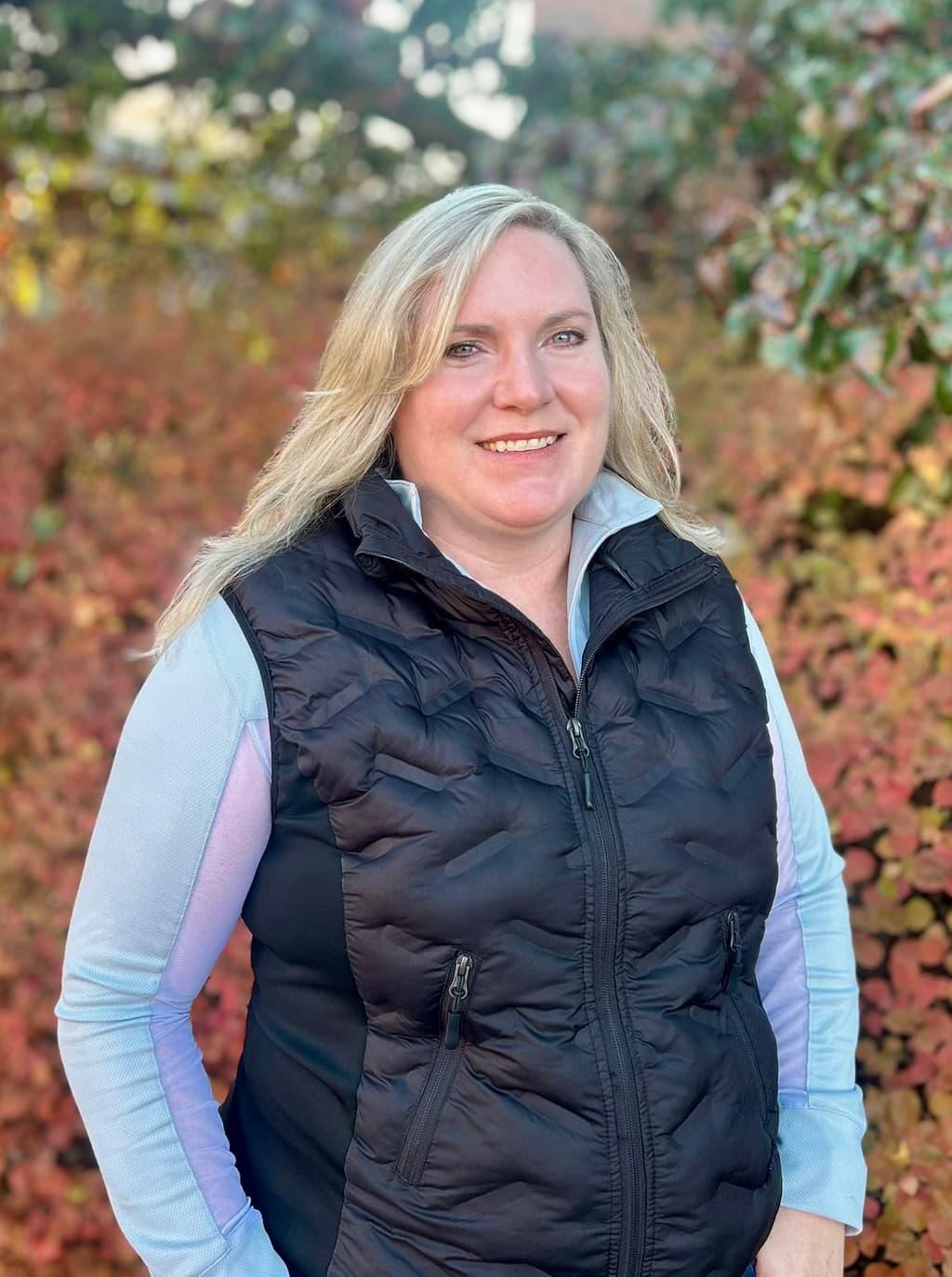 A woman with blonde hair standing outdoors