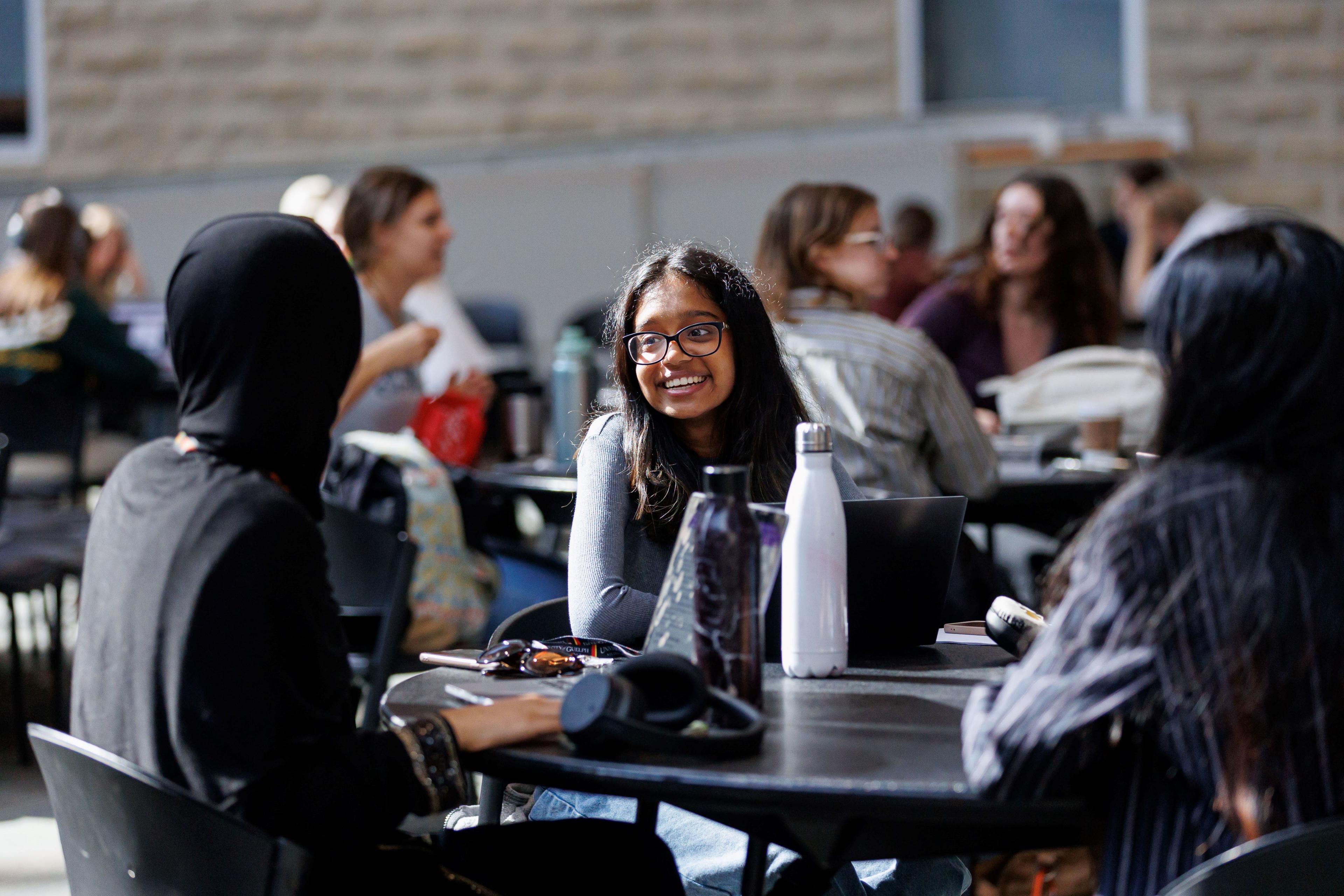 Group of students chatting at the Summerlee Science Complex.