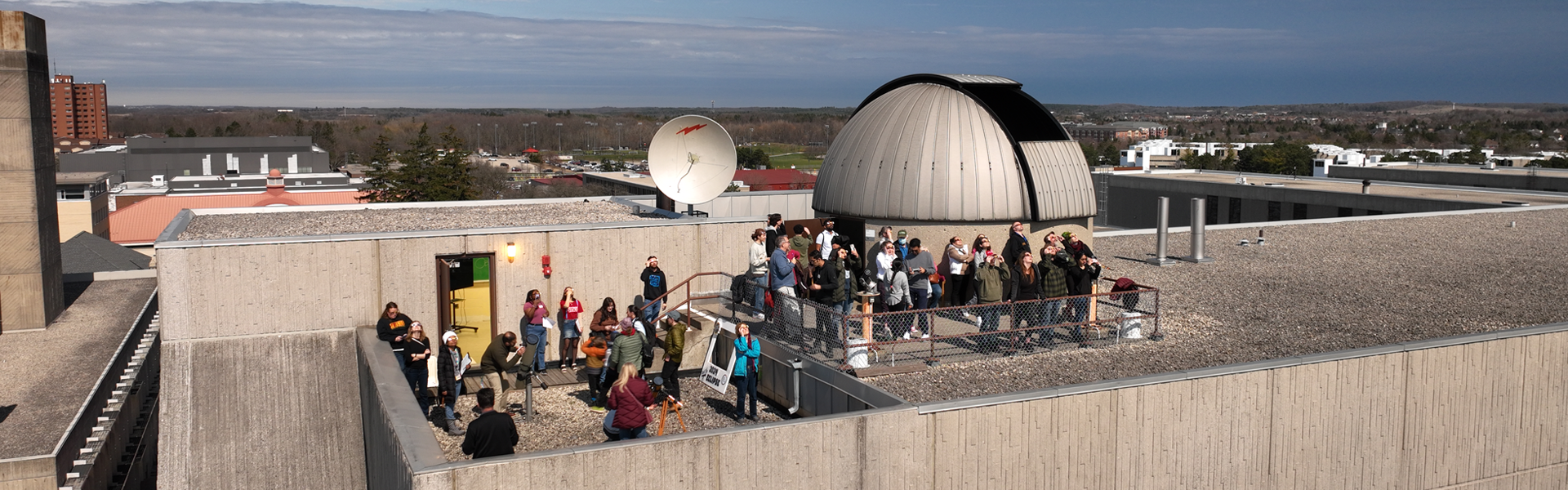 aerial view of the observatory with a group of people outside on the roof