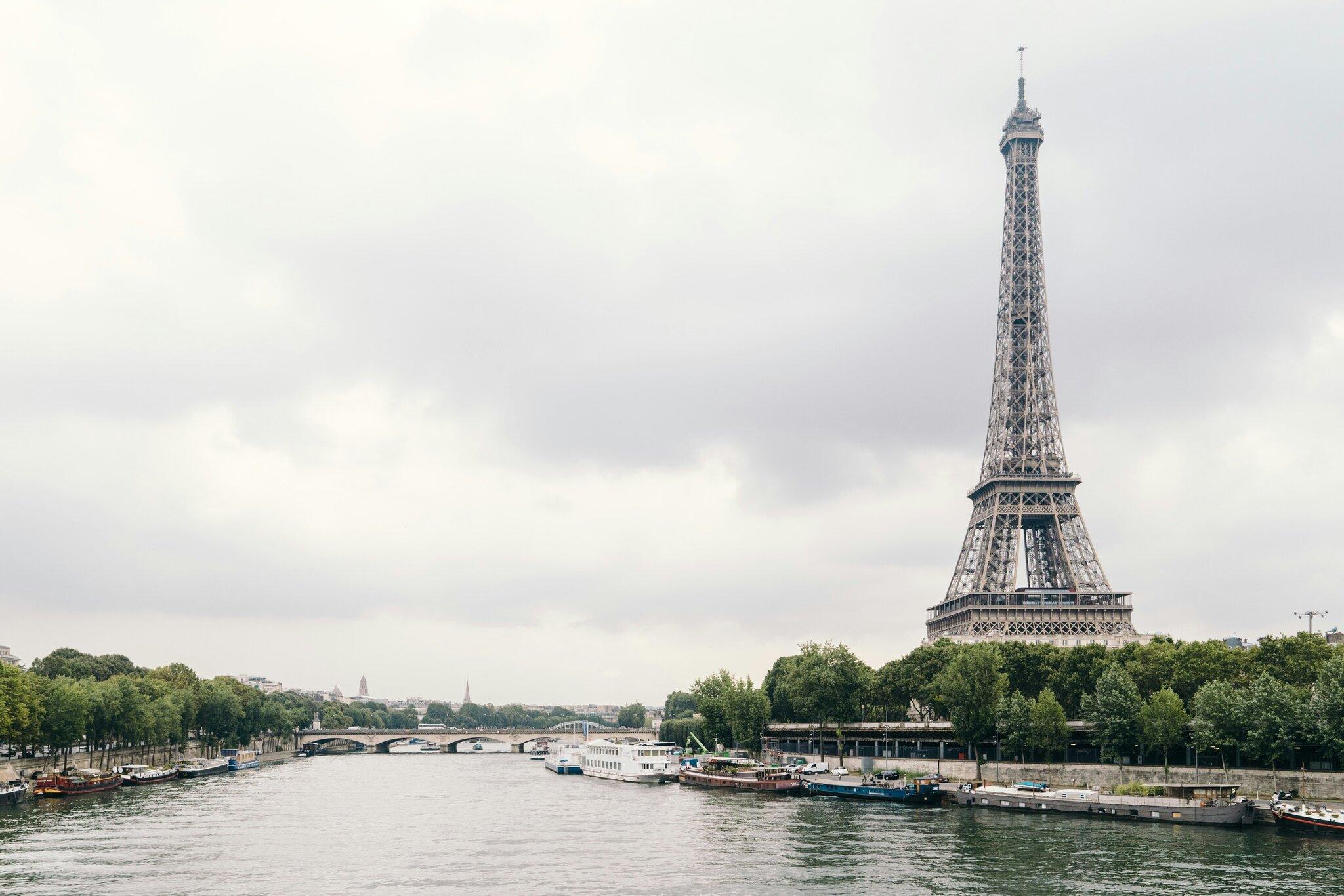The Eiffel Tower stands majestically in Paris, France, showcasing its iconic iron lattice structure against a clear sky.