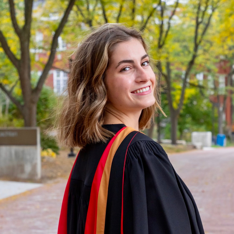 U of G Grad standing Reynolds walk in their gown