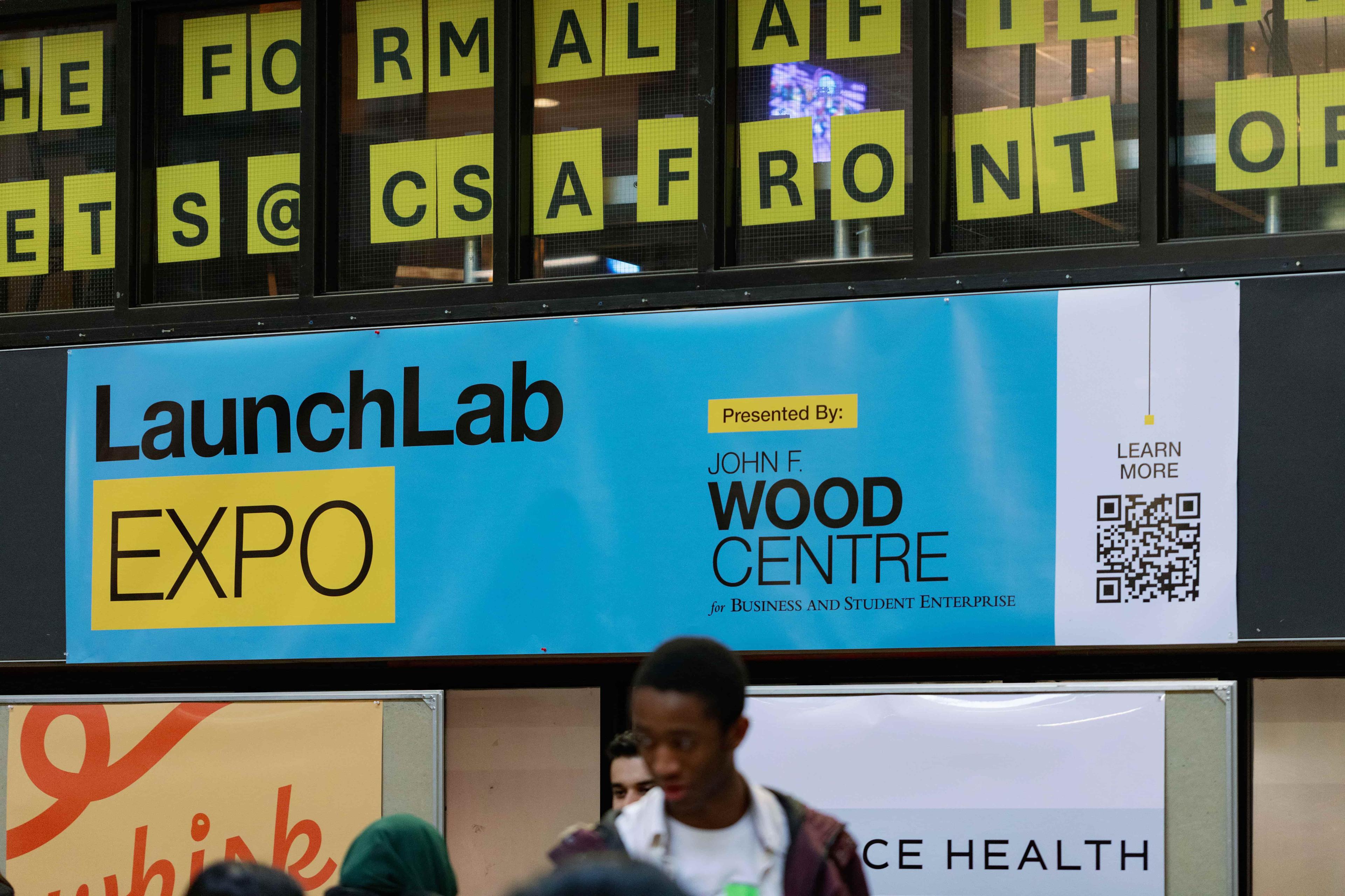 Blue background with a black and yellow logo with text that reads' LaunchLab Expo'