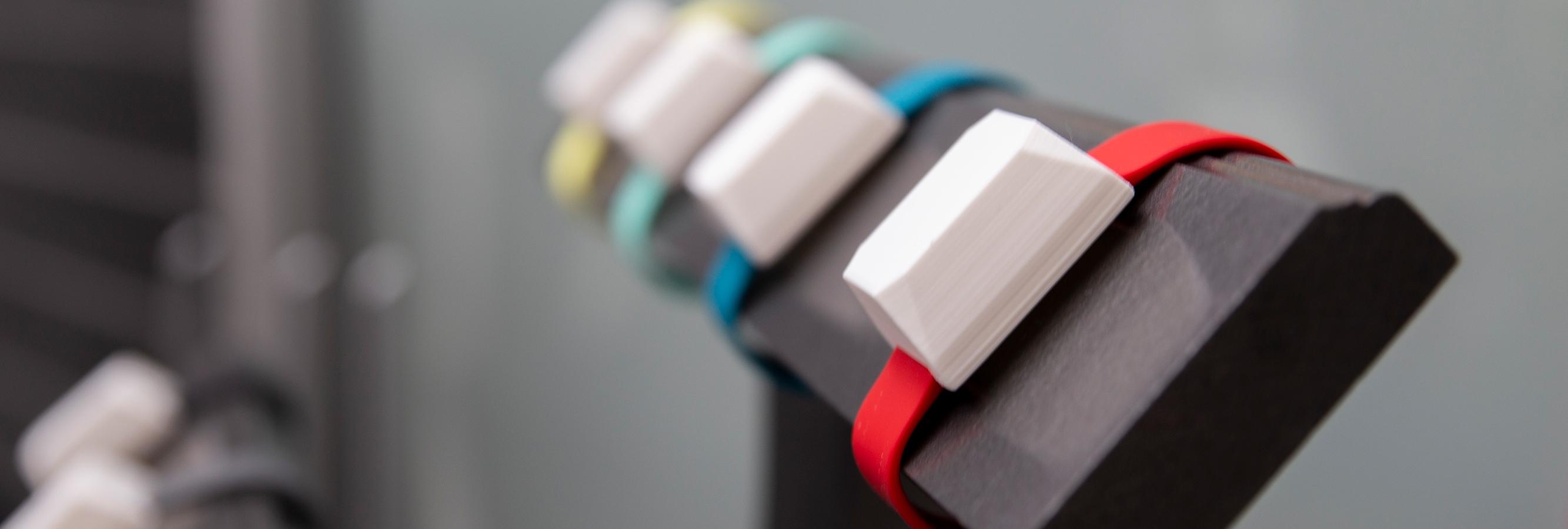 a row of smart watches on a holder