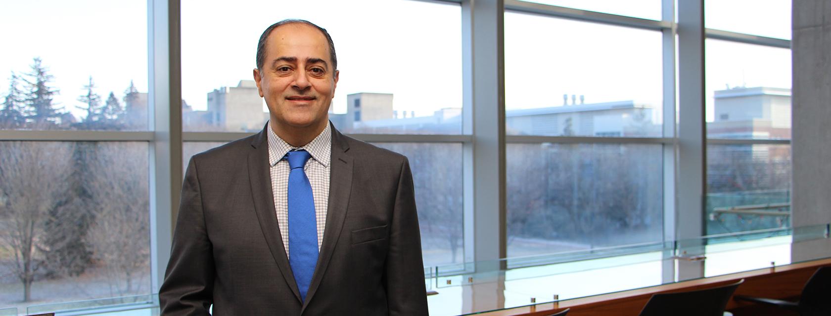 Shayan Sharif smiling for a headshot image