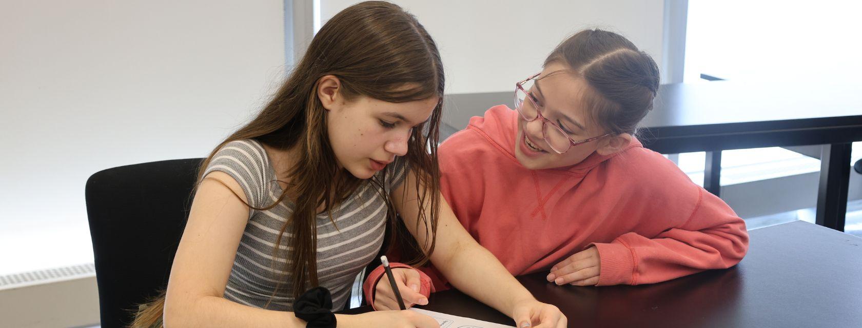 Creative Encounters campers work together on a written assignment.