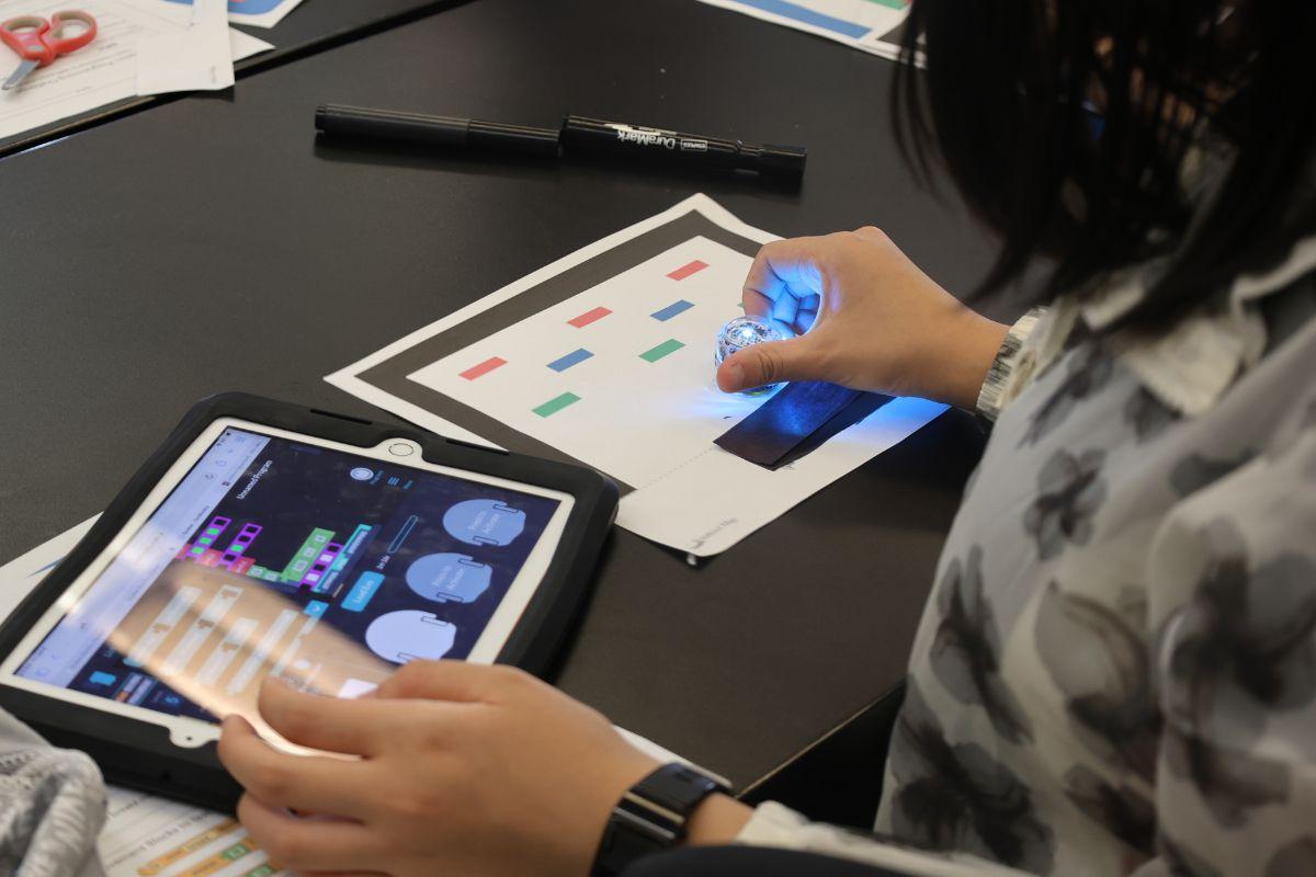 Creative Encounters camper using an Ipad to learn about ai and programming