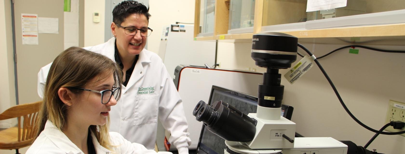 student and prof in a lab
