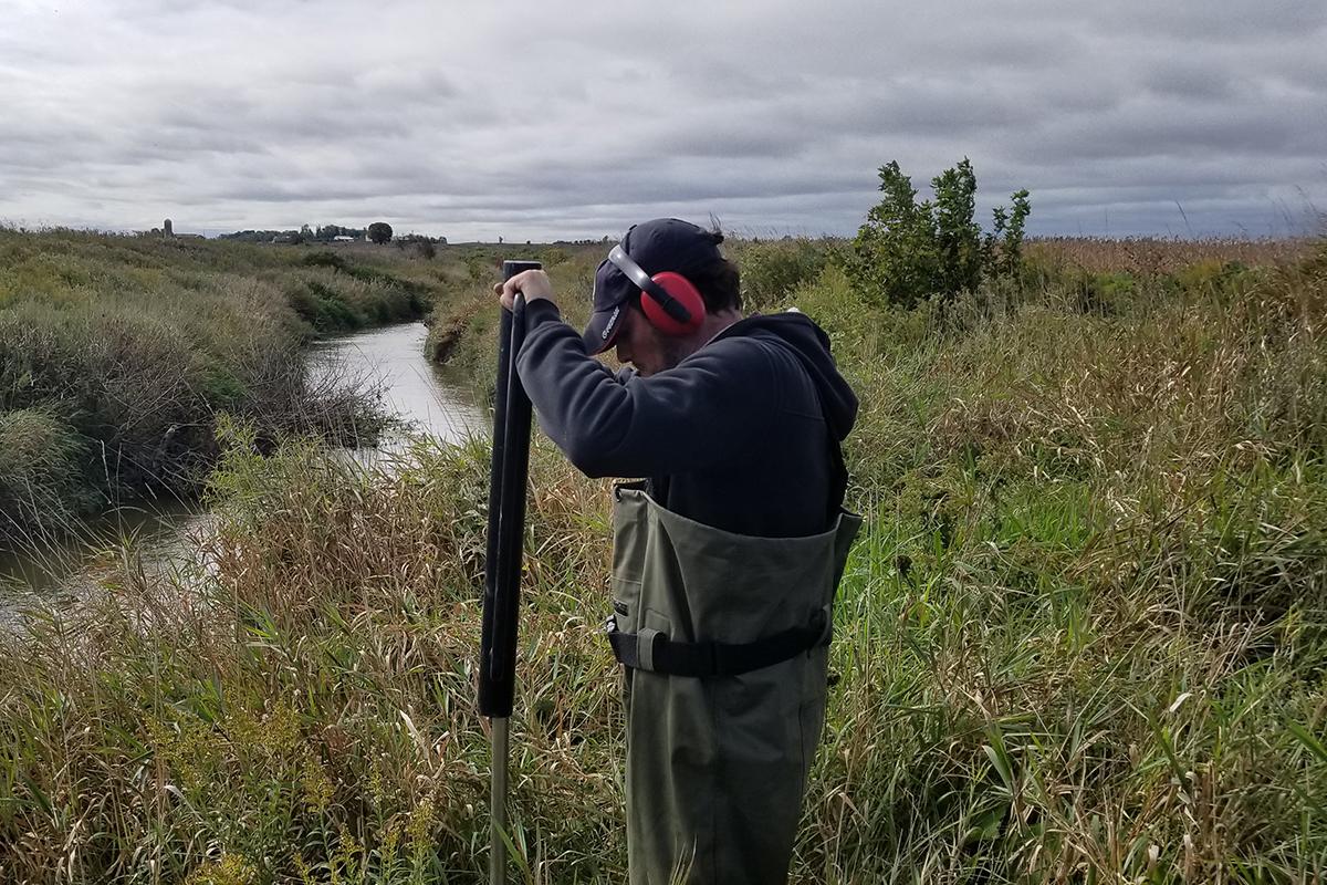 A man using equipment to burrow into the ground