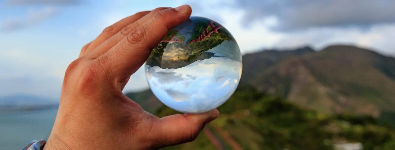 A student views the landscape through a glass globe