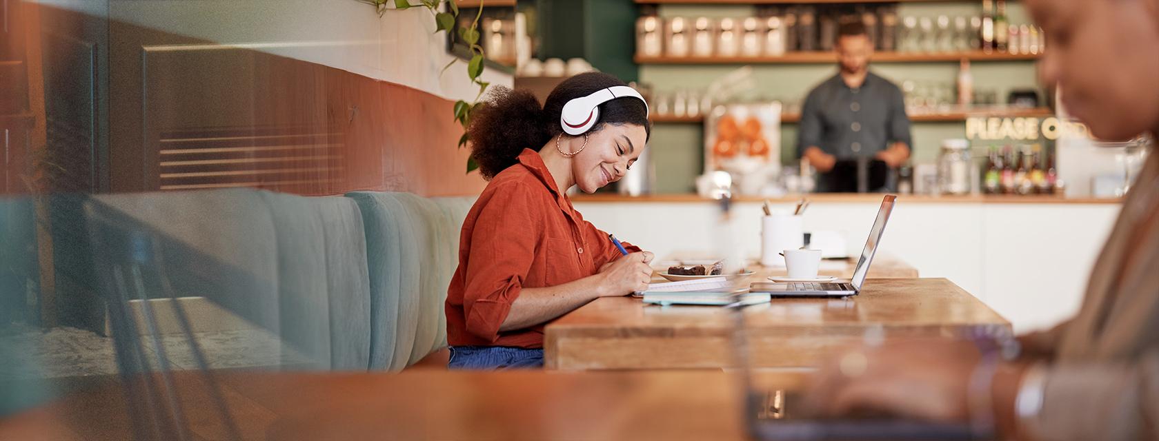 A bachelor of arts student attends online class from a cafe