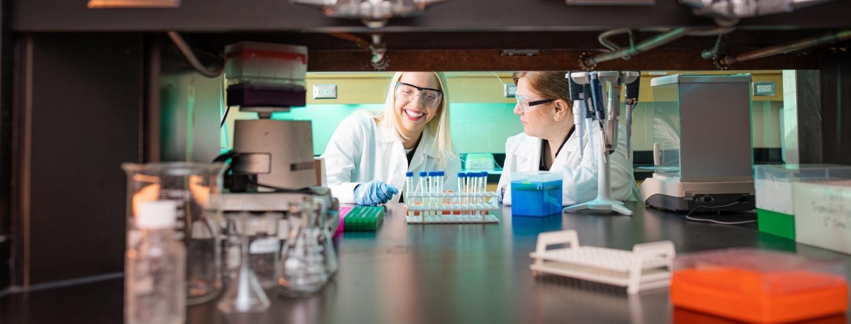 Student and faculty member in a lab