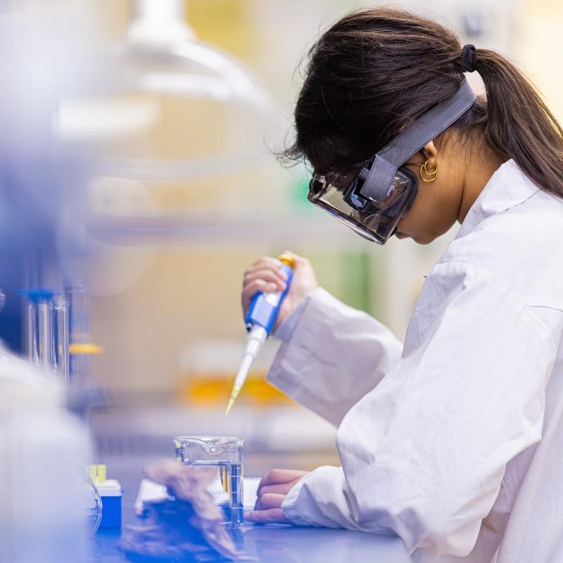 Student pipetting in class