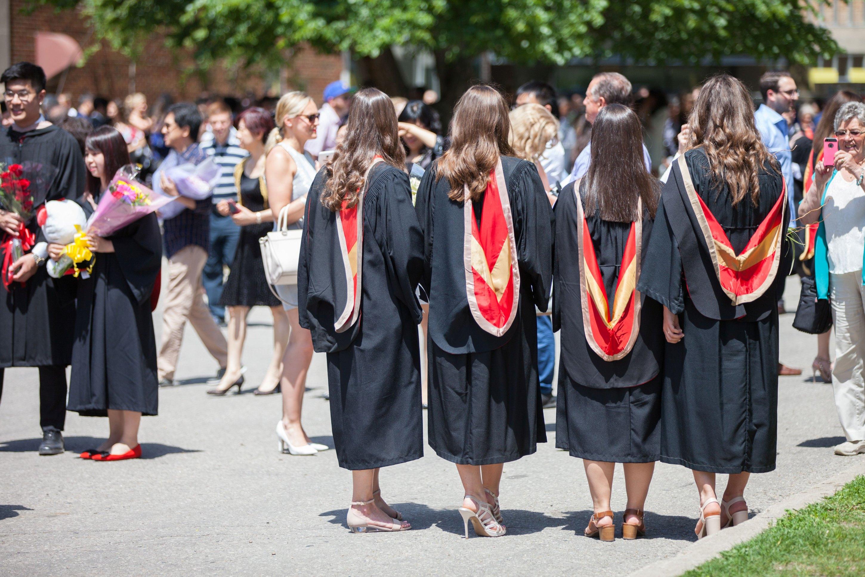students standing for a picture after a convocation ceremony