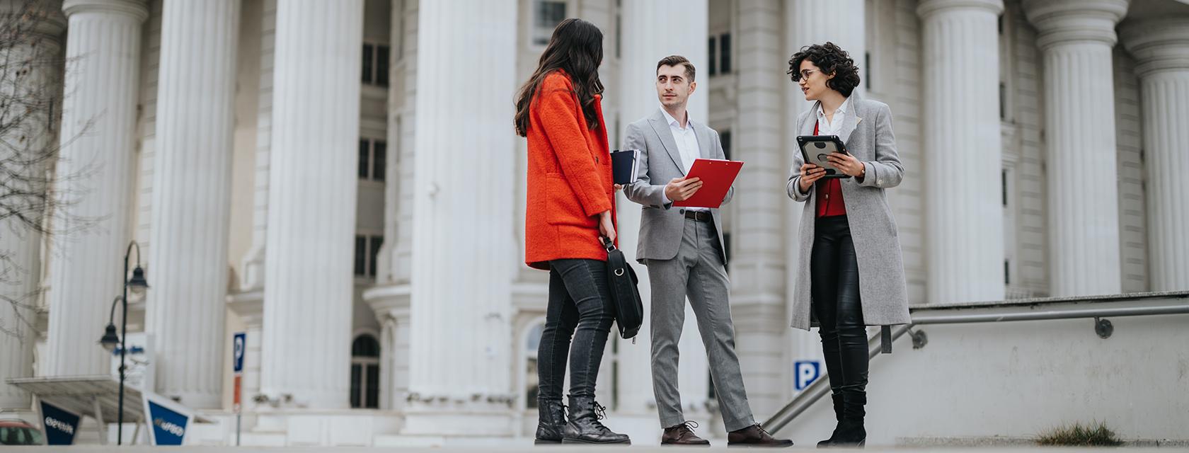 Three criminal justice professionals meet outside the courthouse