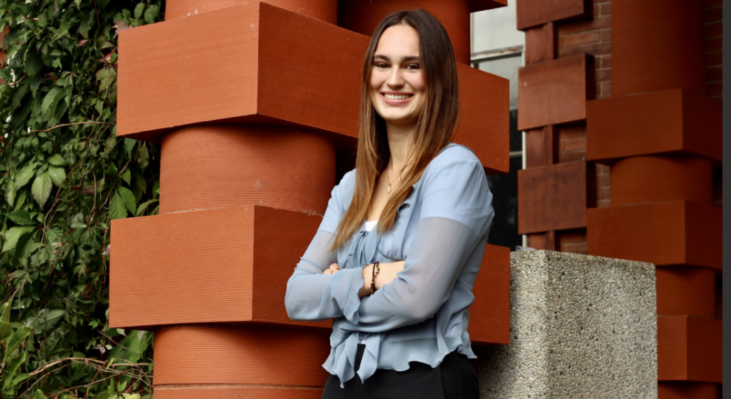 Food Agriculture Business Student Sophia Trothen standing outside a brick building smiling