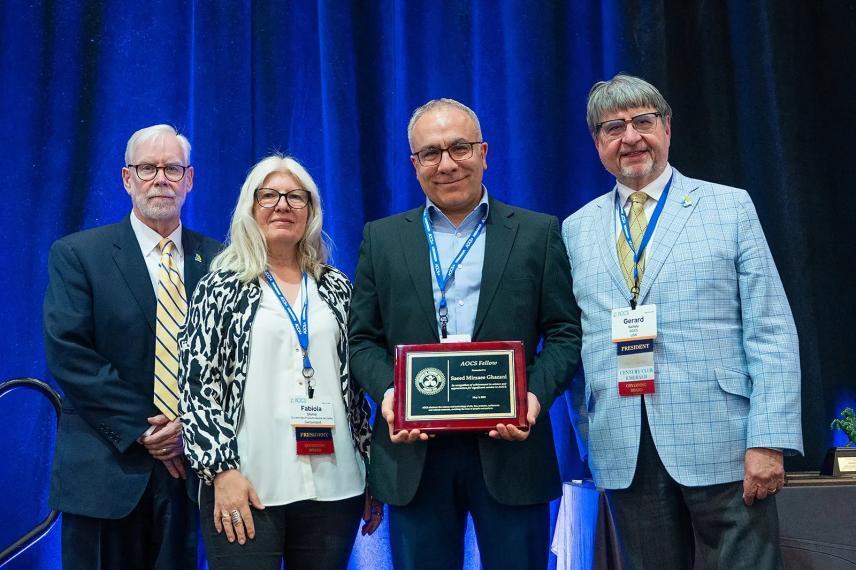 Dr Ghazani receiving a plaque in recognition of his fellowship