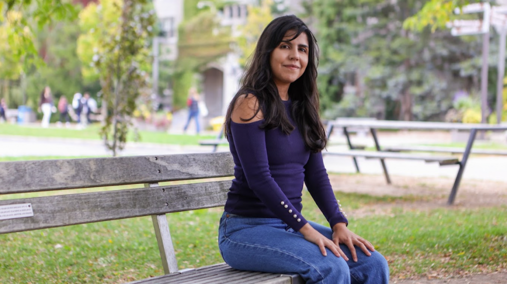 Natalia Piedrahita sitting on a bench outside Johnston hall