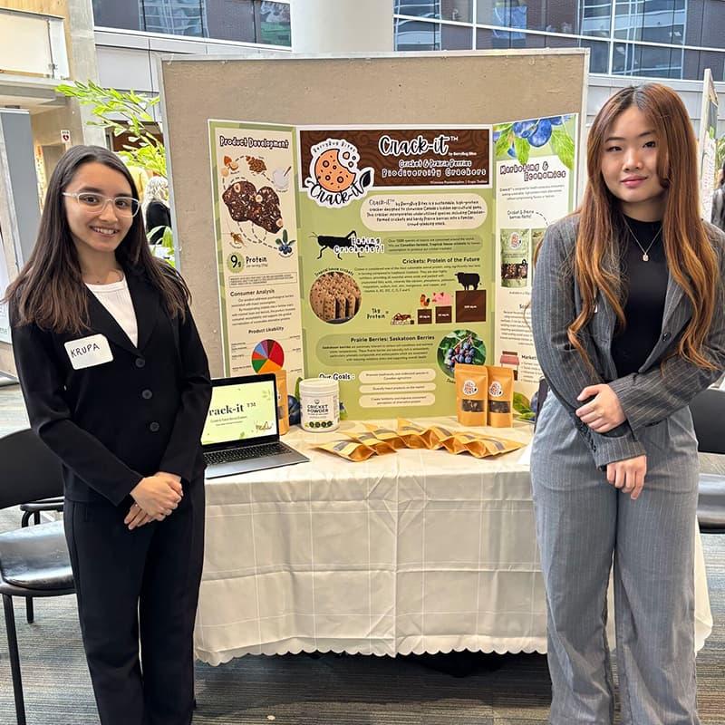 Krupa Thakkar and Wimwipa Prasitnaraphan with their Project SOY Plus Finale Display in March 2026.