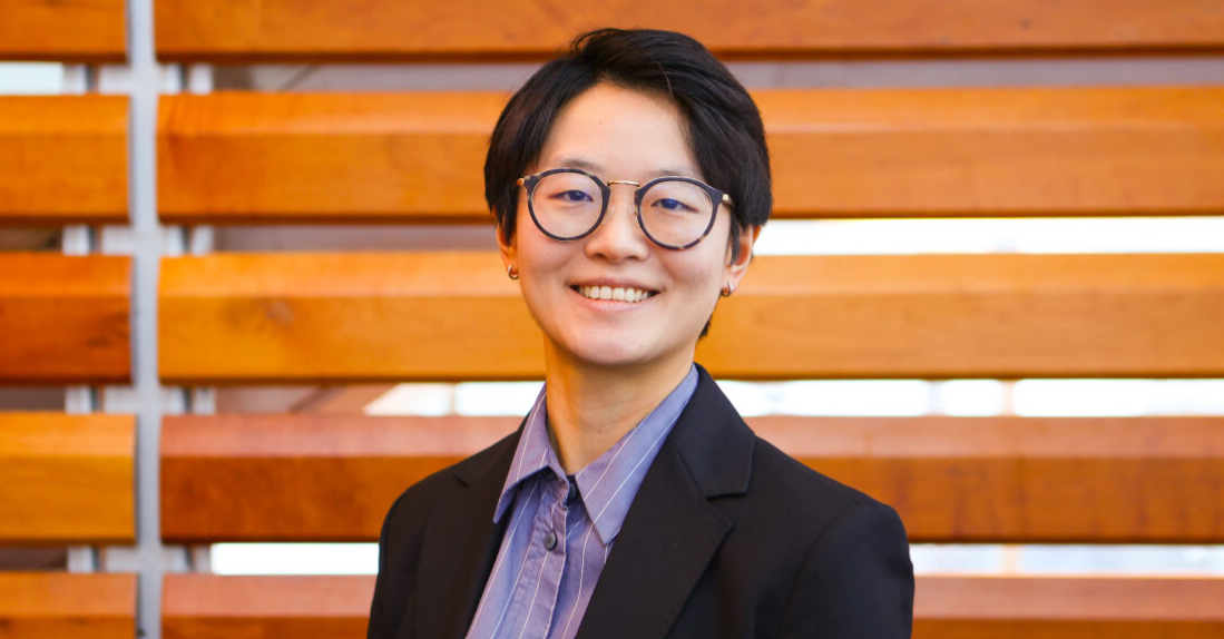 Dr. Wenxi Liao wearing a black blazer and blue dress shirt looking directly at the camera and smiling