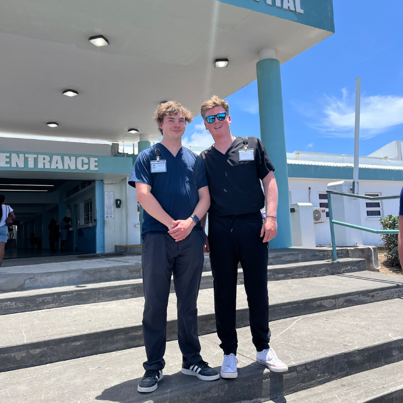 2 male students standing out from of a St.Kitts hospital