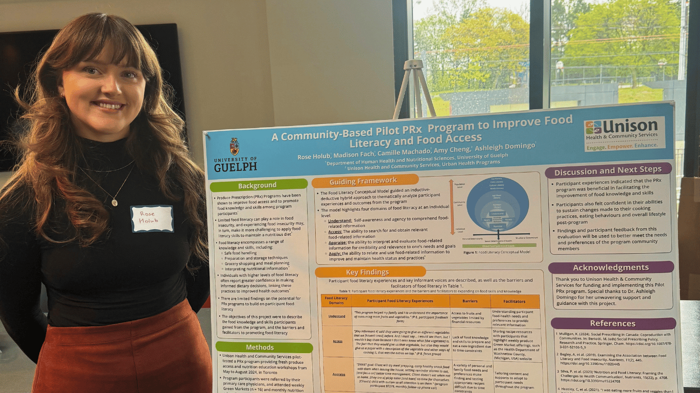 Rose Holub standing next to her findings on a presentation board.