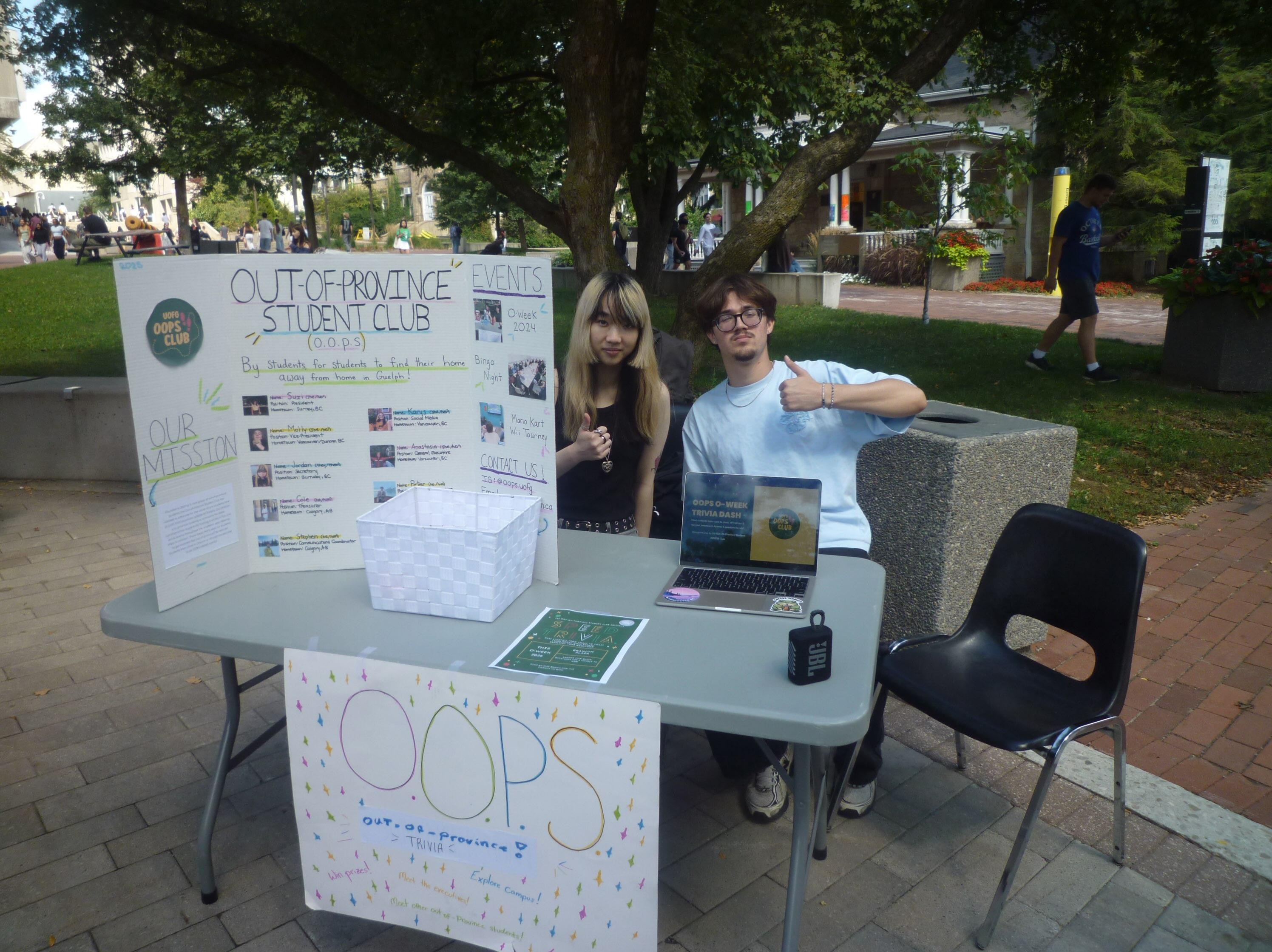 Members of Out of Province Student Club at info booth on campus