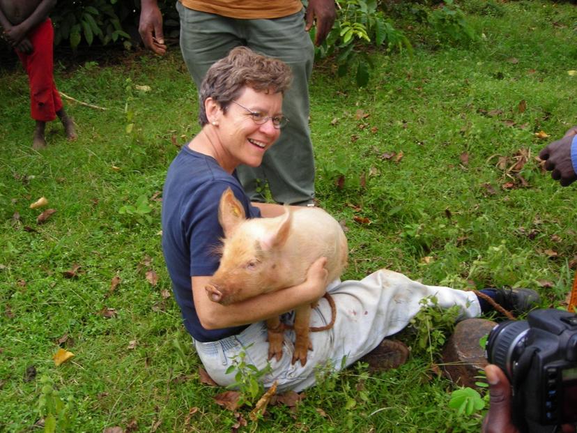 Cate Dewey holding a pig