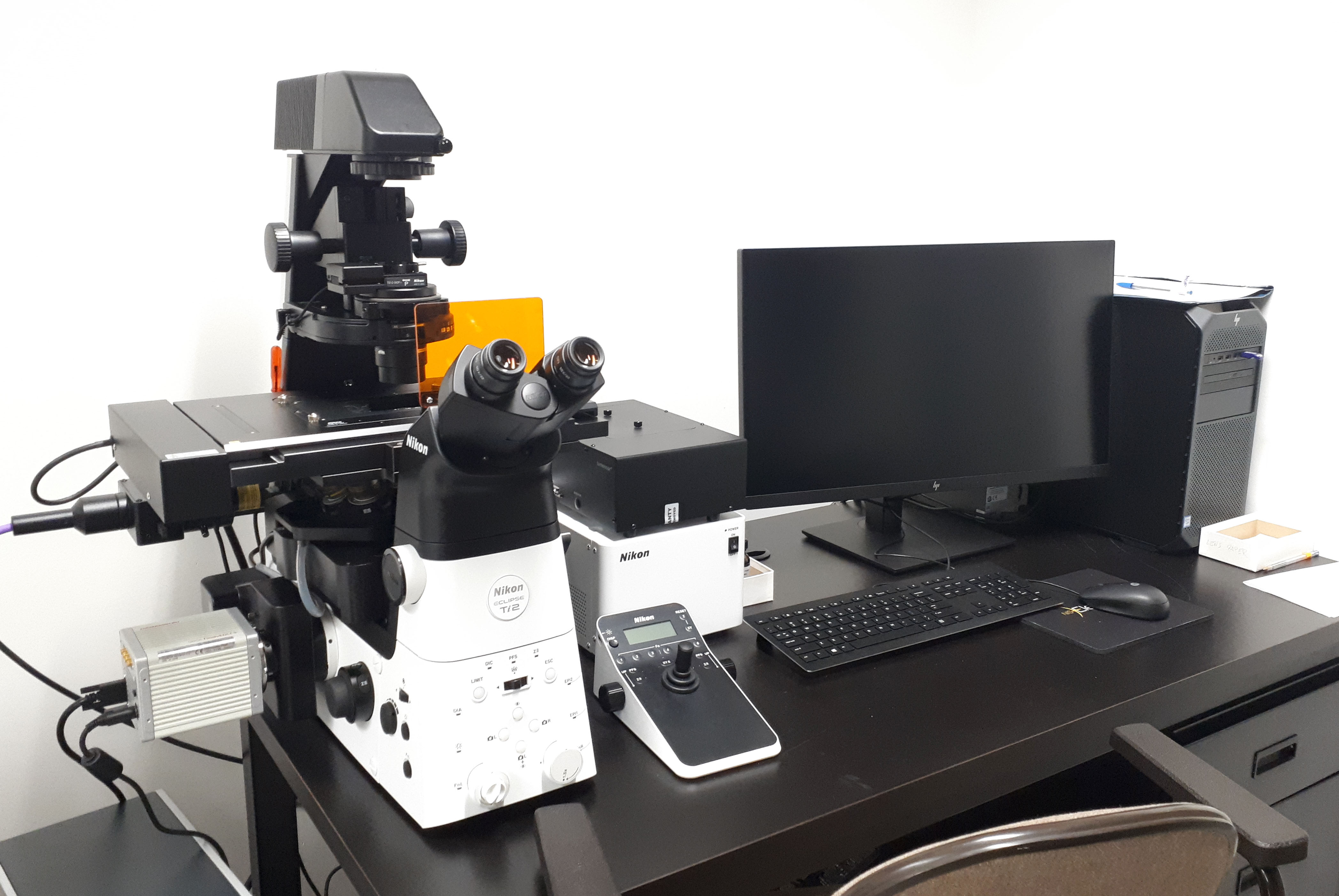 A picture of the Nikon Eclipse Ti2 inverted microscope with accessory equipment and computer