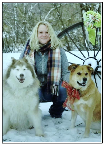 Photo of Megan MacAlpine with her 2 dogs outdoors