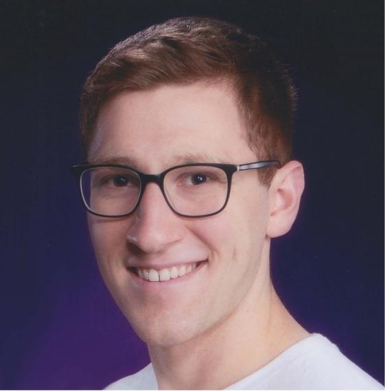 Headshot of Nicholas Werry against a blue backdrop