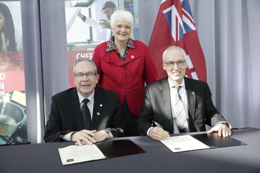 Minister Jeff Leal, MPP Liz Sandals, and UofG President Franco Vaccarino sitting in front of newly signed agreements