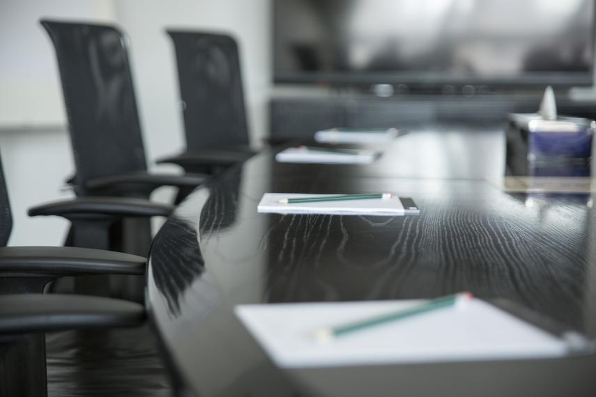 Meeting room with notes pads and pencils at each seat